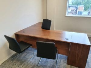 3 chairs around a corner desk