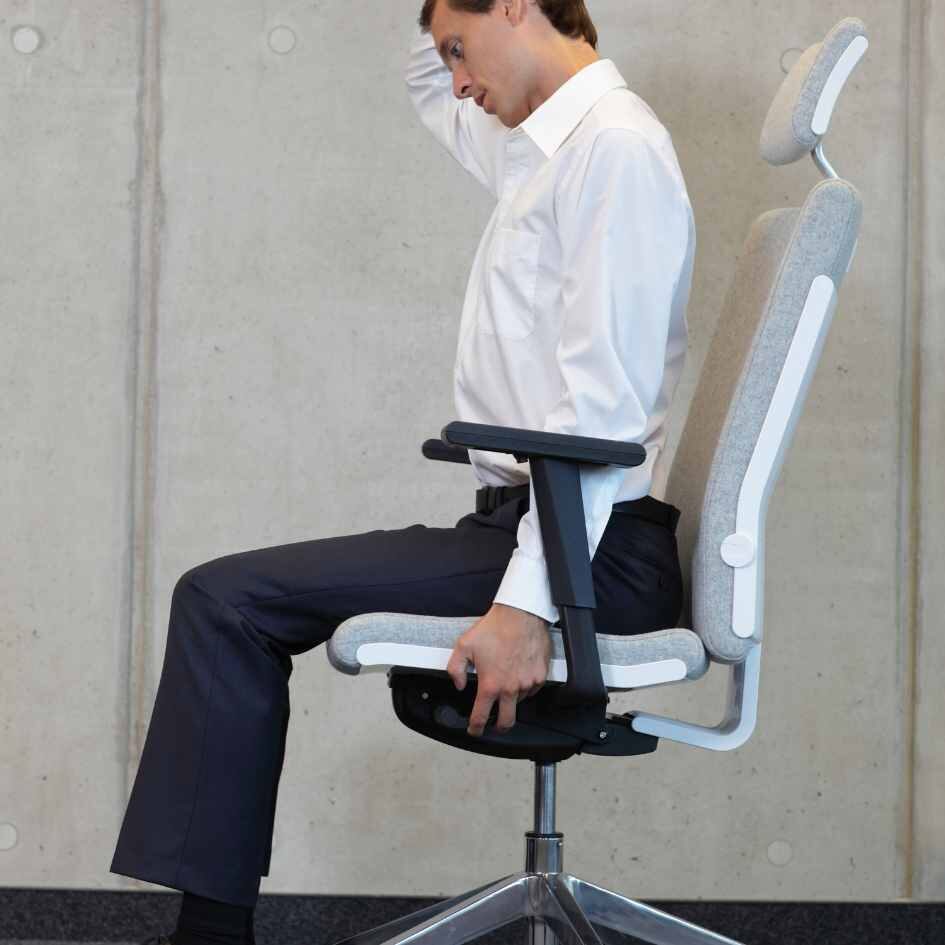 man sitting in ergonomic office chair from Pure Office Solutions